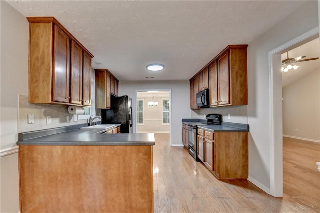 310 Andrew Ridge Drive Jefferson, GA 30549 - Photo 22 of 52 a kitchen with stainless steel appliances granite countertop a refrigerator a stove top oven a sink and dishwasher
