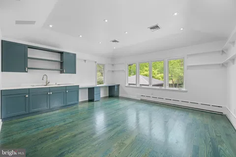 a view of kitchen with wooden floor and electronic appliances