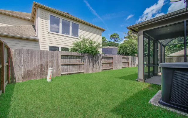 a view of house with backyard