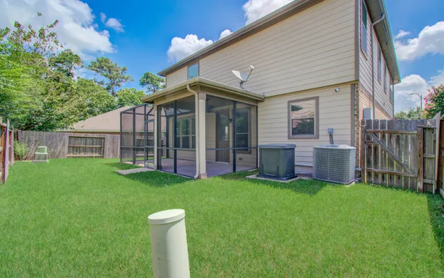 a view of a house with a yard and porch