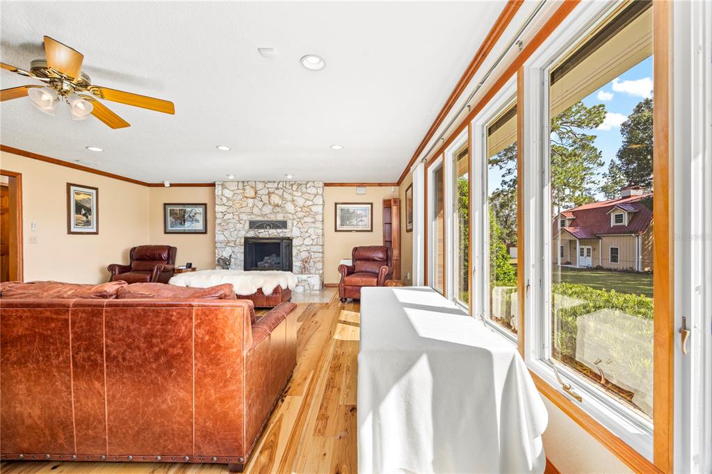 3897 Pinemount Road Lake City, FL 32024 - Photo 35 of 70 a living room with furniture a fireplace and a flat screen tv