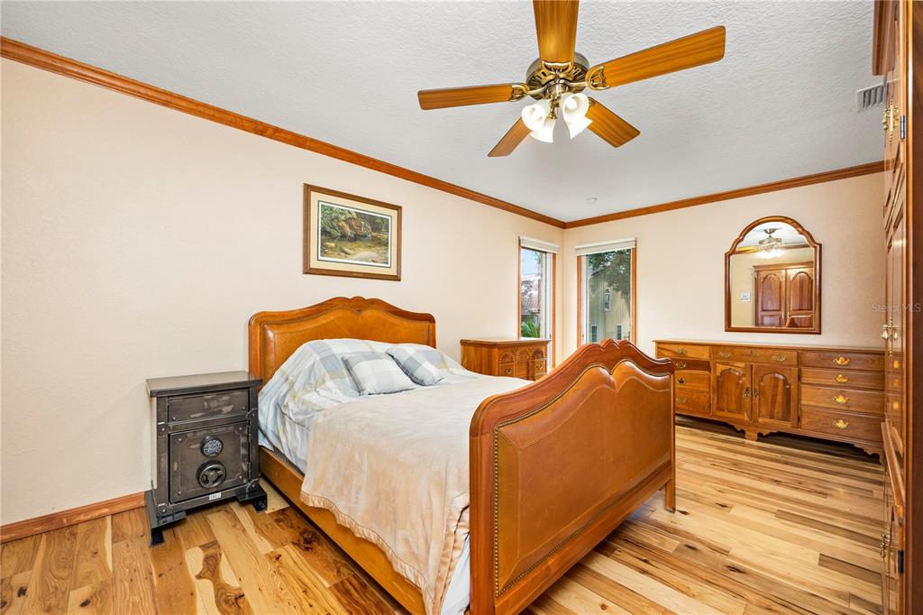 3897 Pinemount Road Lake City, FL 32024 - Photo 44 of 70 a bedroom with a bed and wooden floor