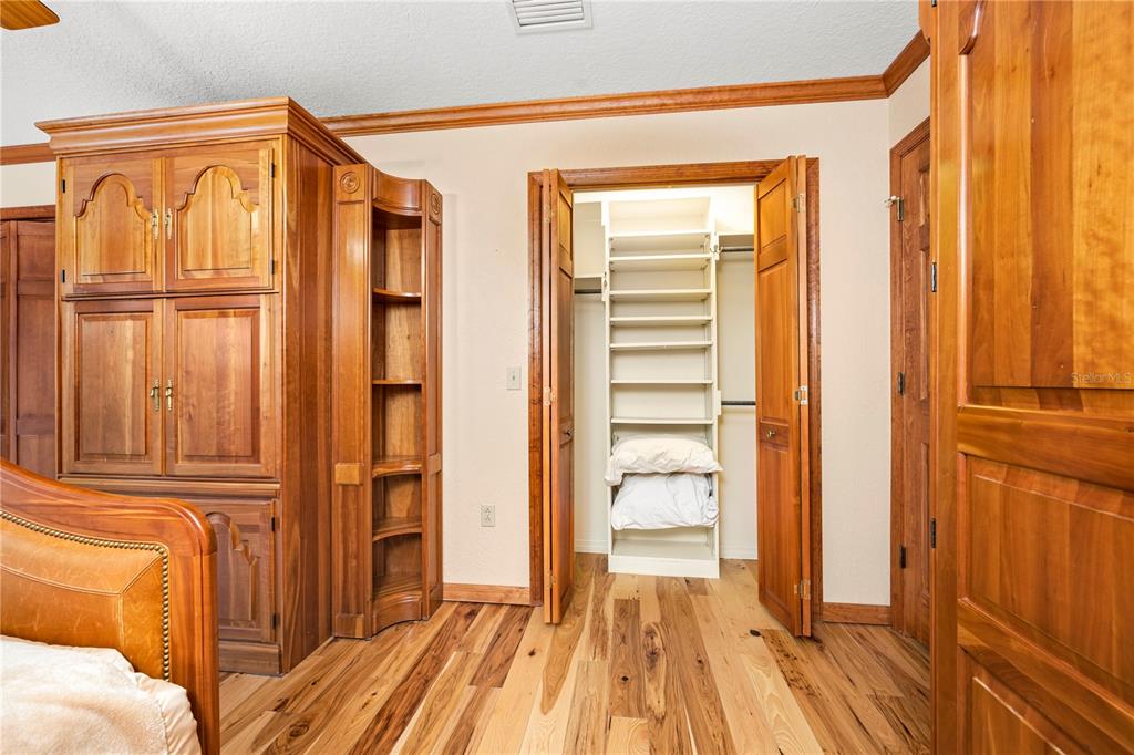 3897 Pinemount Road Lake City, FL 32024 - Photo 46 of 70 a view of a bedroom with wooden floor and windows