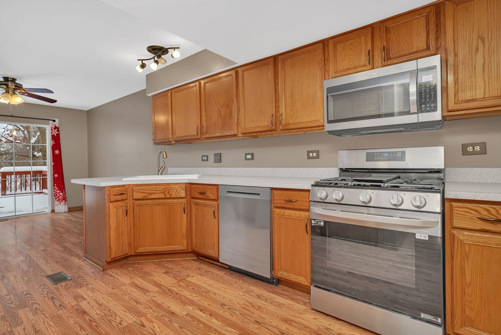936 Treeline Court Lockport, IL 60441 - Photo 7 of 29 a kitchen with stainless steel appliances granite countertop a stove microwave and cabinets