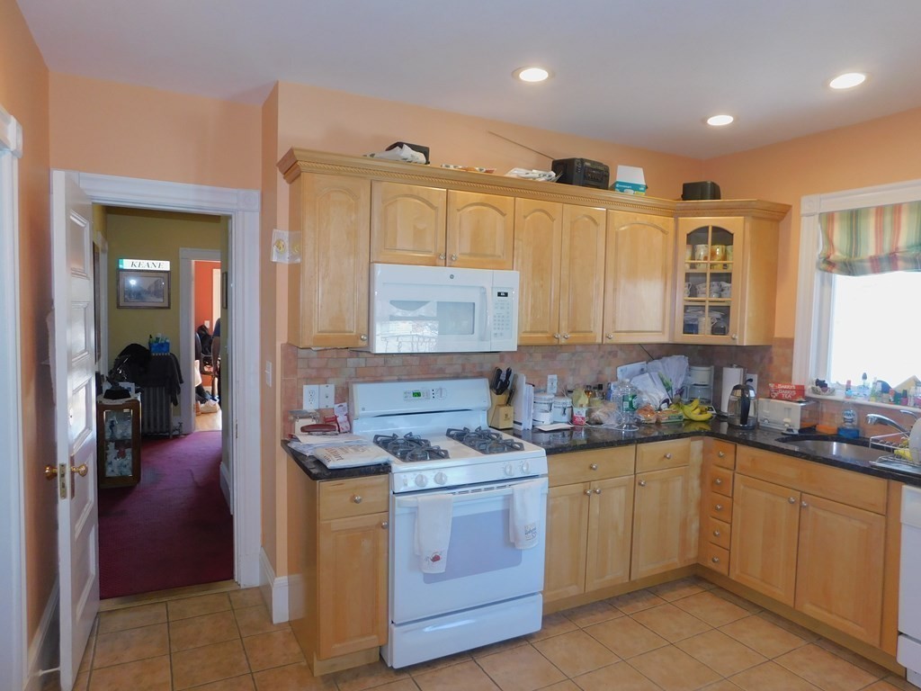 145 Lagrange Street Boston, MA 02132 - Photo 16 of 37 a kitchen with a sink stove and cabinets
