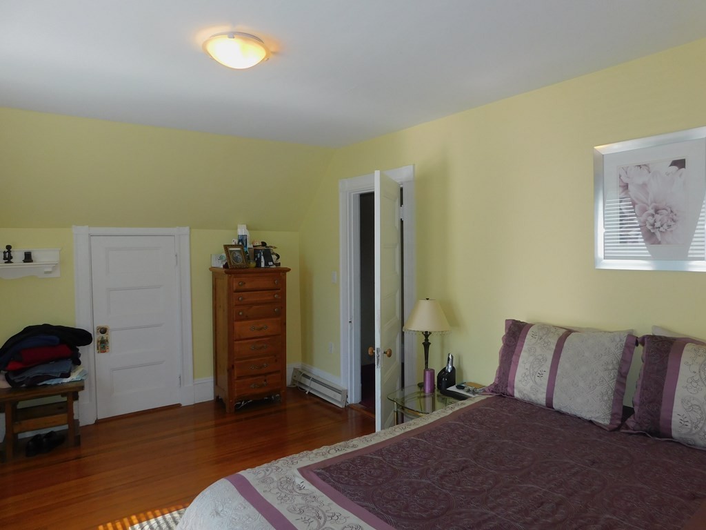 145 Lagrange Street Boston, MA 02132 - Photo 20 of 37 a bed room with a bed and a chair
