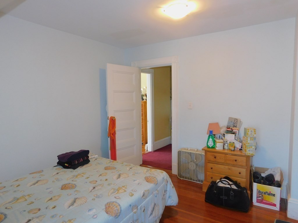 145 Lagrange Street Boston, MA 02132 - Photo 22 of 37 a bedroom with a bed and a dresser