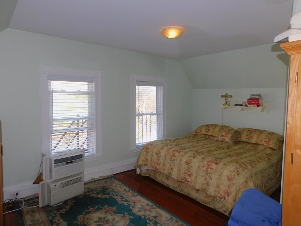 145 Lagrange Street Boston, MA 02132 - Photo 23 of 37 a bedroom with a bed and a window