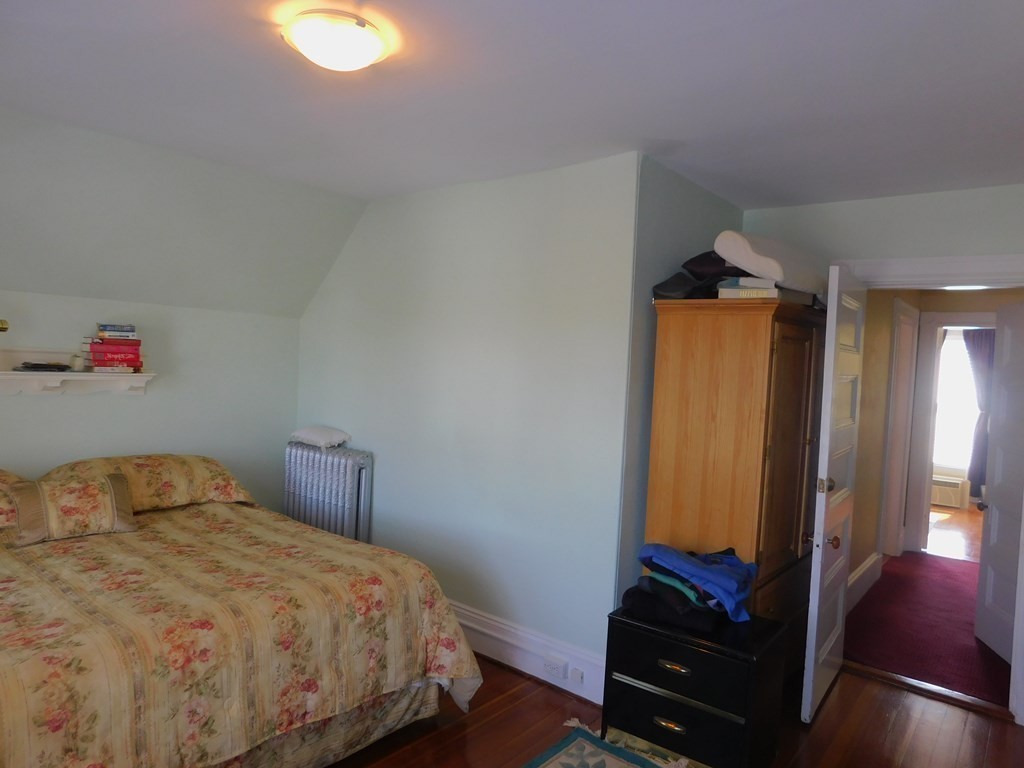 145 Lagrange Street Boston, MA 02132 - Photo 24 of 37 a bedroom with a bed and a flat screen tv