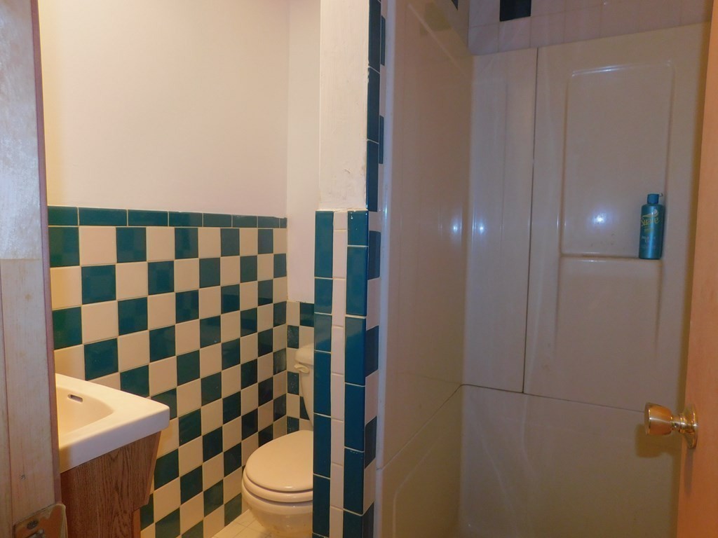 145 Lagrange Street Boston, MA 02132 - Photo 28 of 37 a bathroom with a toilet and a shower