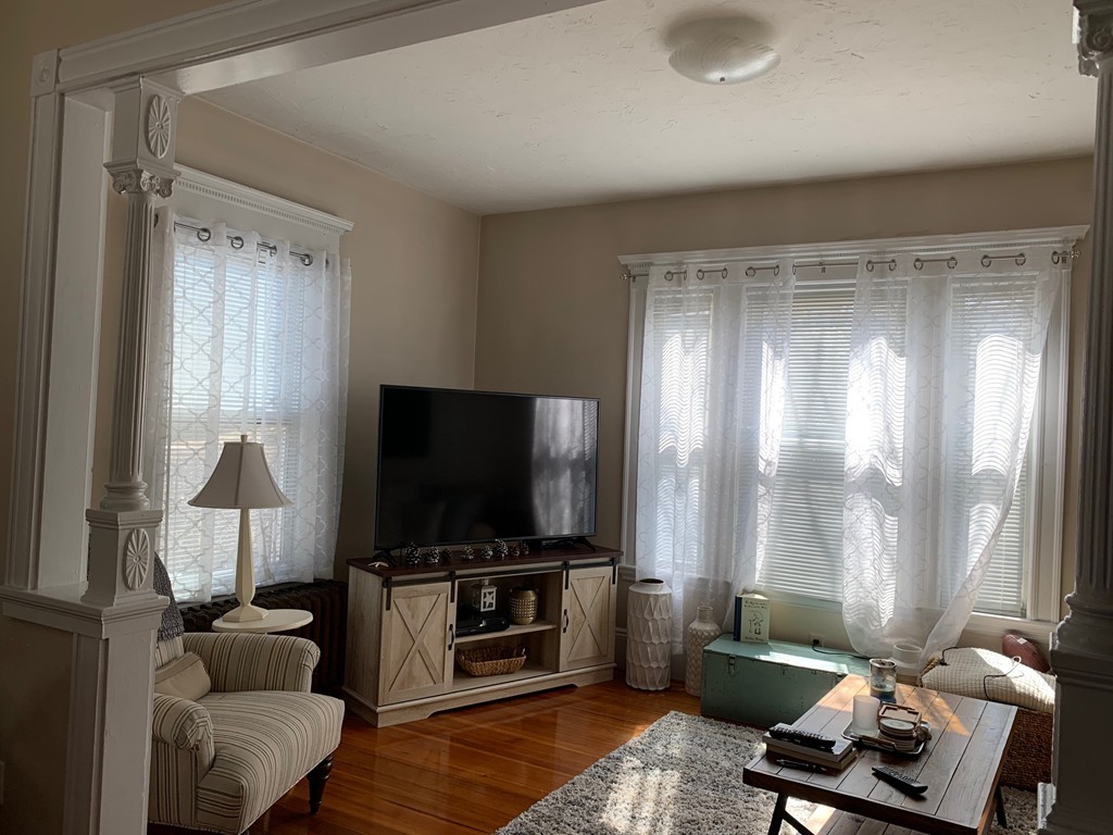 145 Lagrange Street Boston, MA 02132 - Photo 4 of 37 a living room with furniture and a flat screen tv
