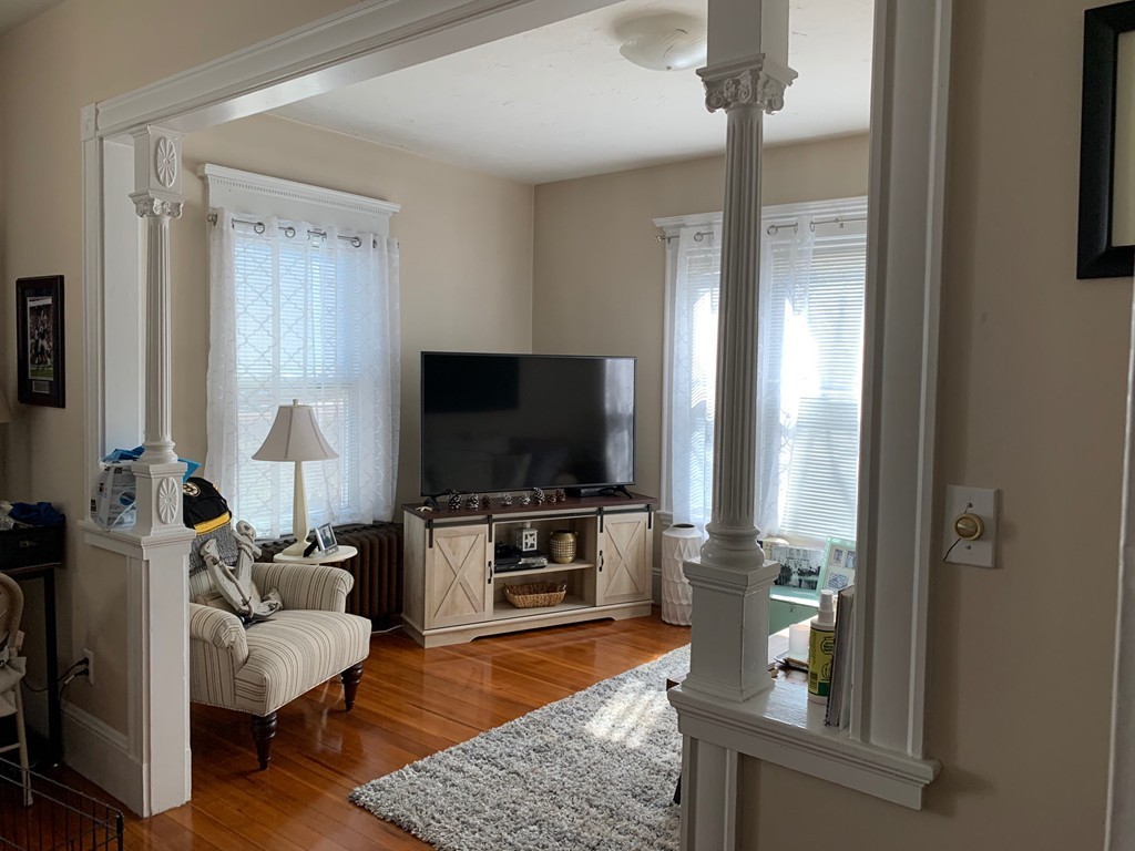 145 Lagrange Street Boston, MA 02132 - Photo 5 of 37 a living room with furniture and a flat screen tv