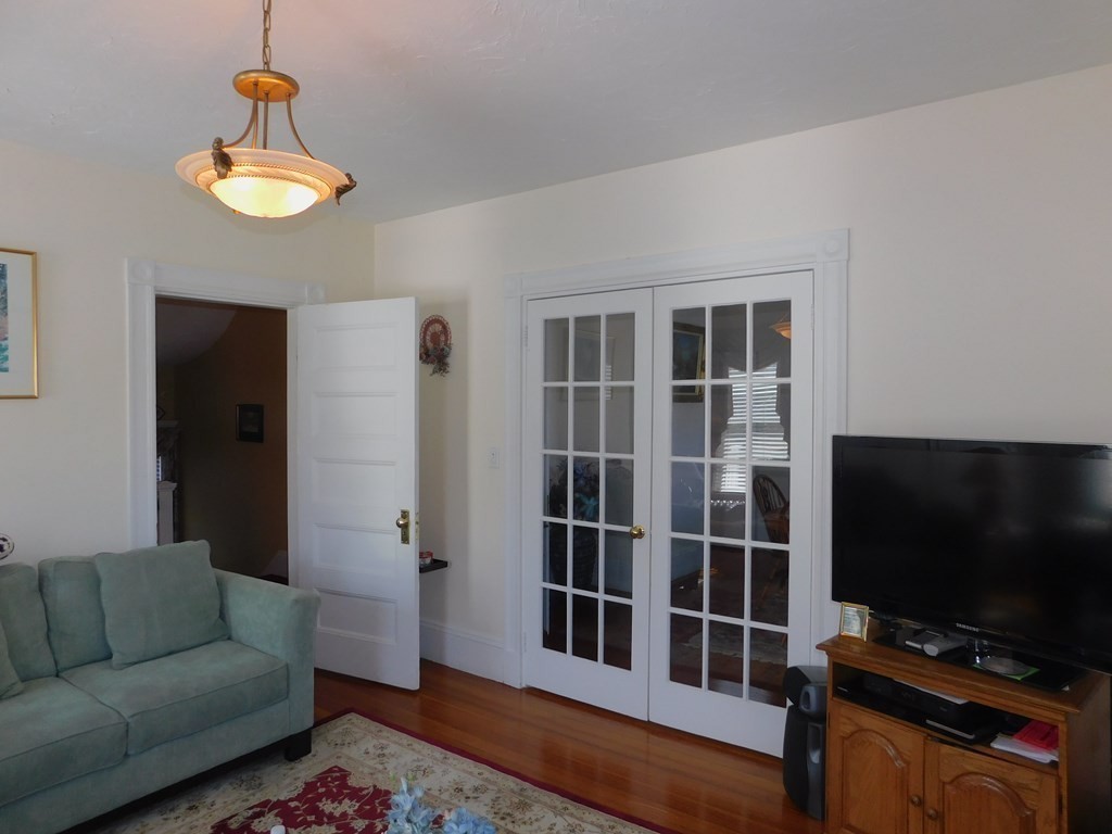 145 Lagrange Street Boston, MA 02132 - Photo 8 of 37 a living room with furniture and a flat screen tv