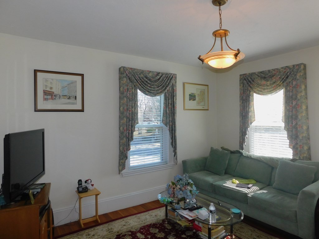 145 Lagrange Street Boston, MA 02132 - Photo 9 of 37 a living room with furniture and a window
