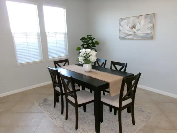 a dining room with furniture and window
