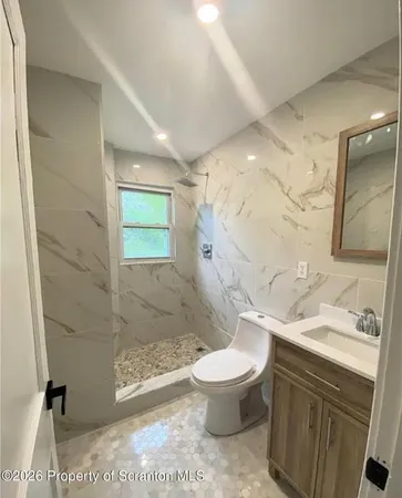 a bathroom with a sink toilet and shower