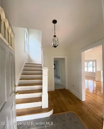 a view of entryway and hall with wooden floor