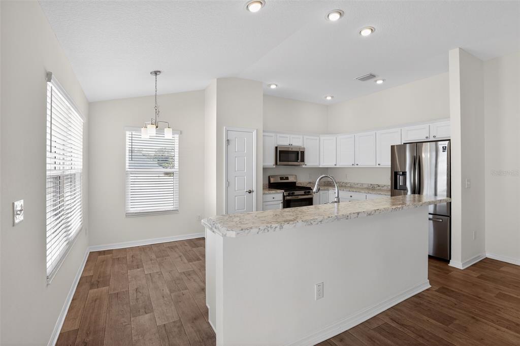 6273 Windham Way The Villages, FL 32163 - Photo 12 of 32 a kitchen with stainless steel appliances a refrigerator sink and microwave