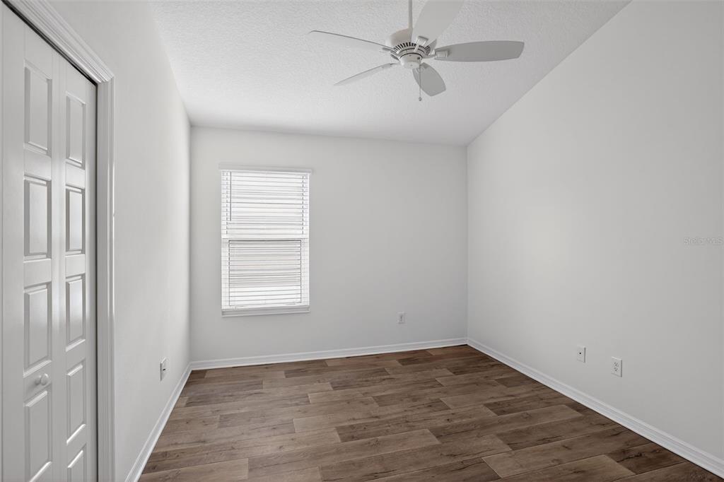 6273 Windham Way The Villages, FL 32163 - Photo 17 of 32 an empty room with a window and a fan