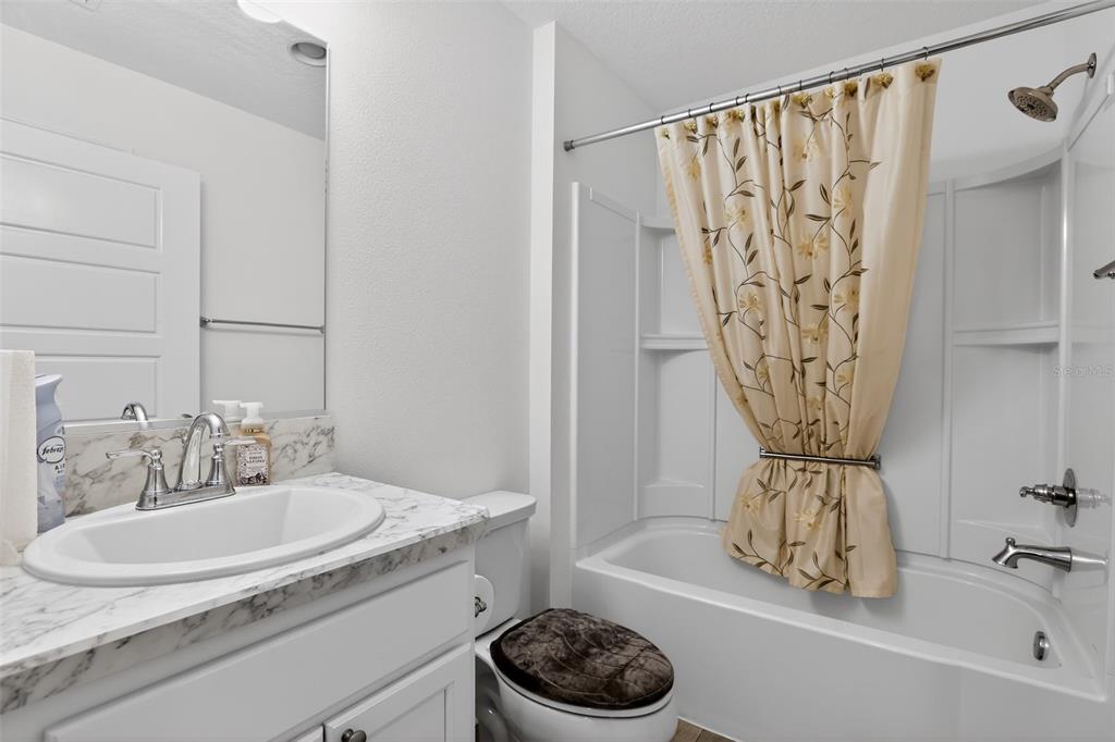 6273 Windham Way The Villages, FL 32163 - Photo 22 of 32 a bathroom with a sink a toilet and a shower