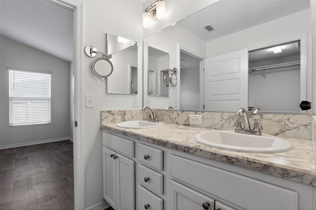 6273 Windham Way The Villages, FL 32163 - Photo 23 of 32 a bathroom with a granite countertop double vanity sink and mirror