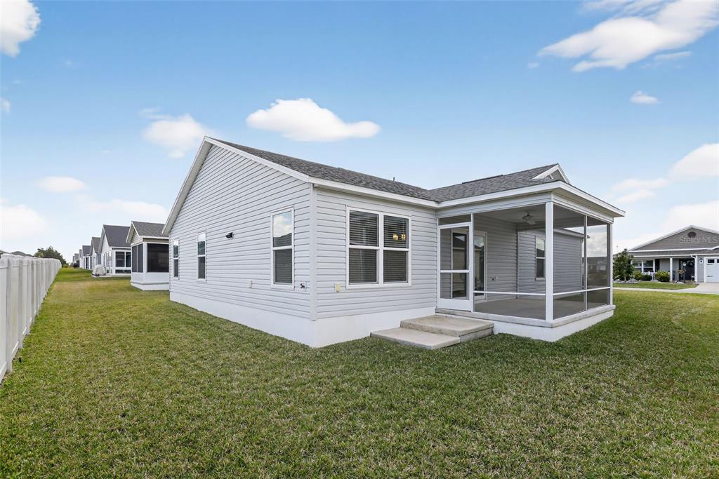 6273 Windham Way The Villages, FL 32163 - Photo 29 of 32 a front view of house with yard and green space