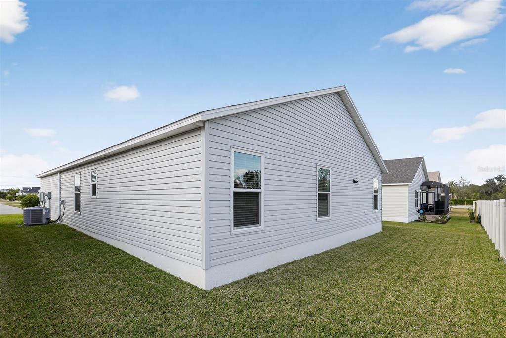 6273 Windham Way The Villages, FL 32163 - Photo 30 of 32 a view of a house with a yard