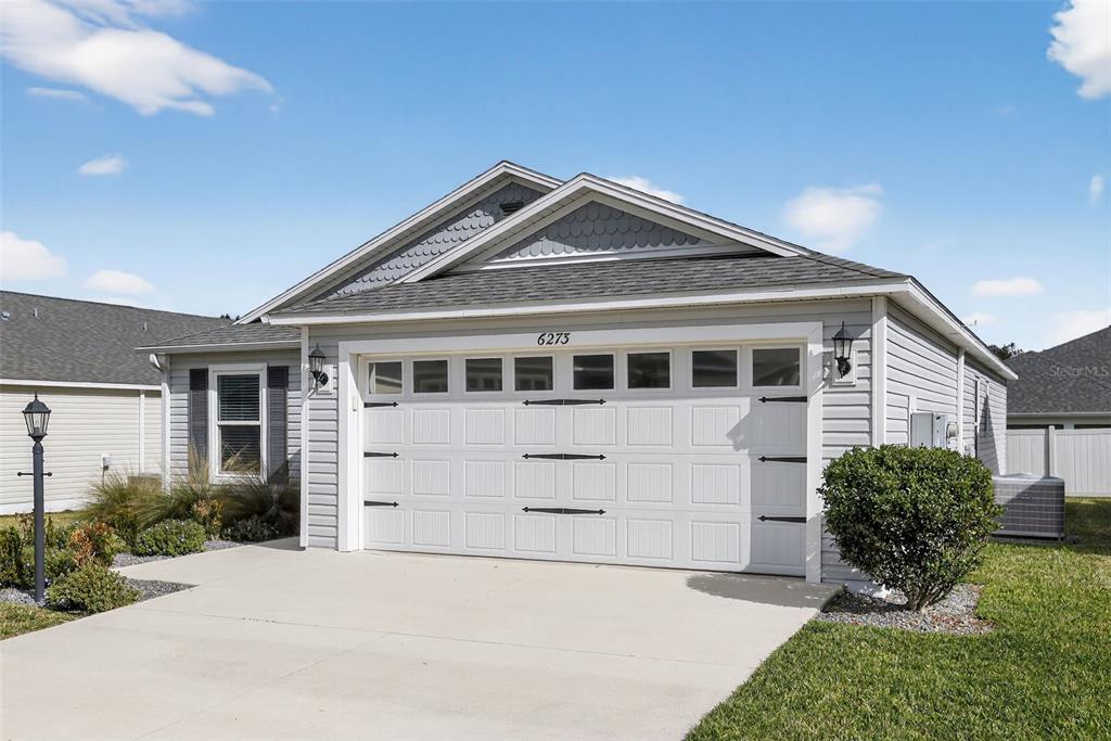 6273 Windham Way The Villages, FL 32163 - Photo 3 of 32 a front view of a house with a yard