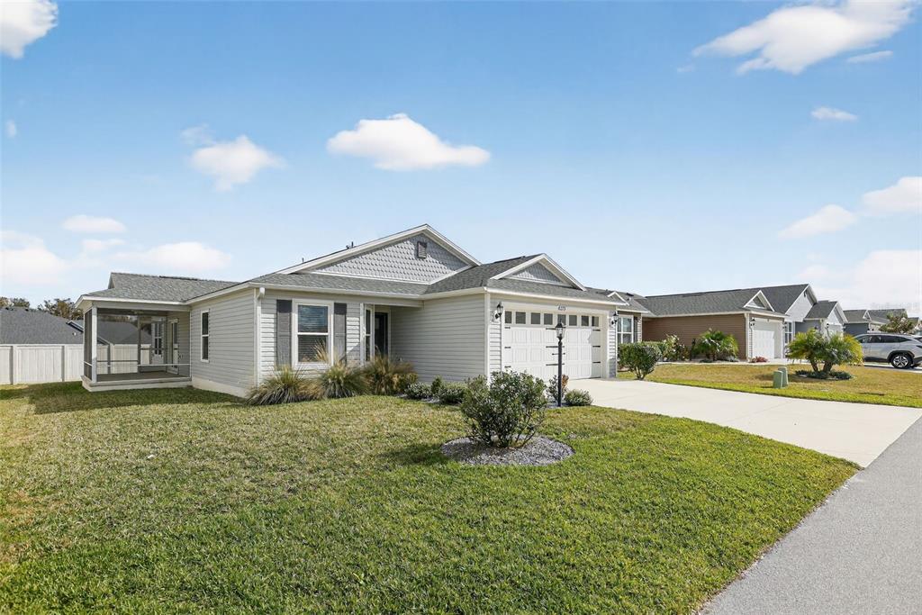 6273 Windham Way The Villages, FL 32163 - Photo 5 of 32 a front view of a house with a yard