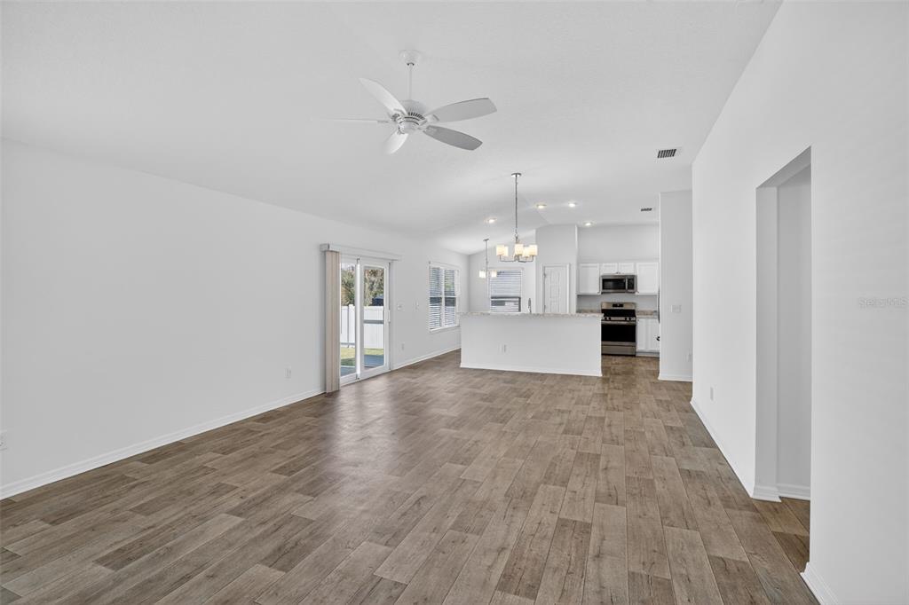 6273 Windham Way The Villages, FL 32163 - Photo 6 of 32 a view of a kitchen with a sink and a refrigerator