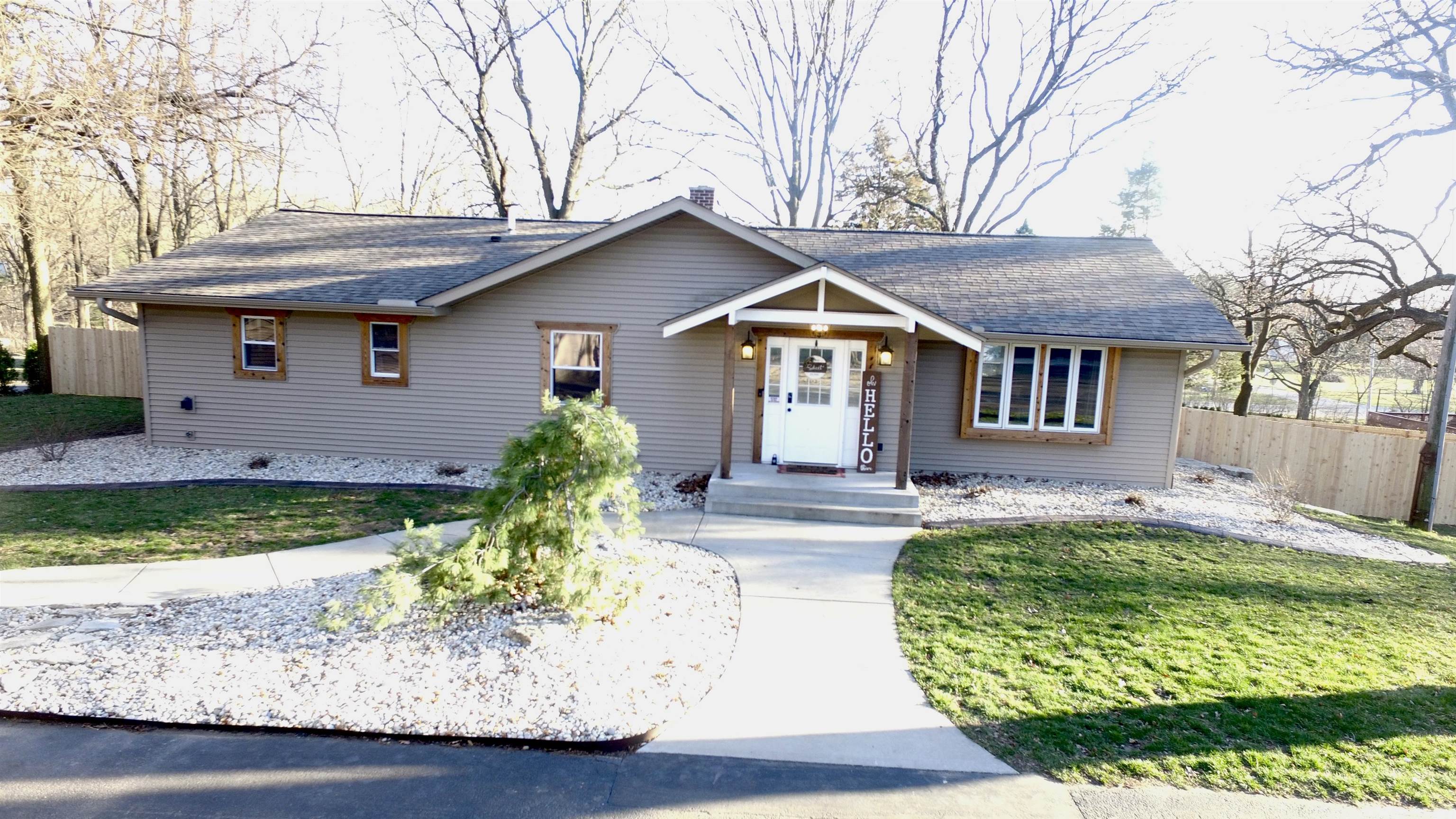 6912 Elevator Road Roscoe, IL 61073 - Photo 1 of 43 a front view of a house with garden