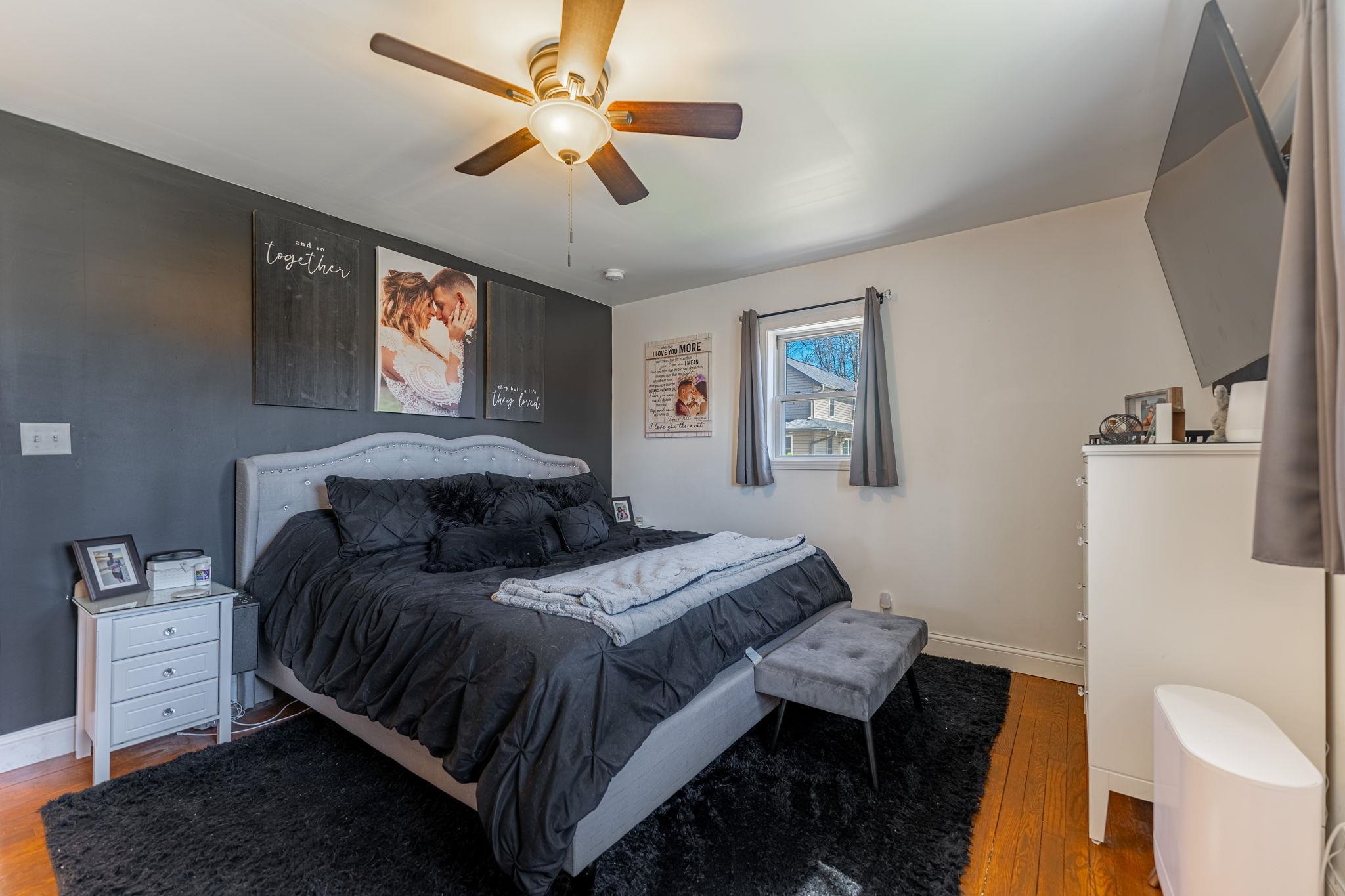 6912 Elevator Road Roscoe, IL 61073 - Photo 11 of 43 a bedroom with a bed and a chandelier