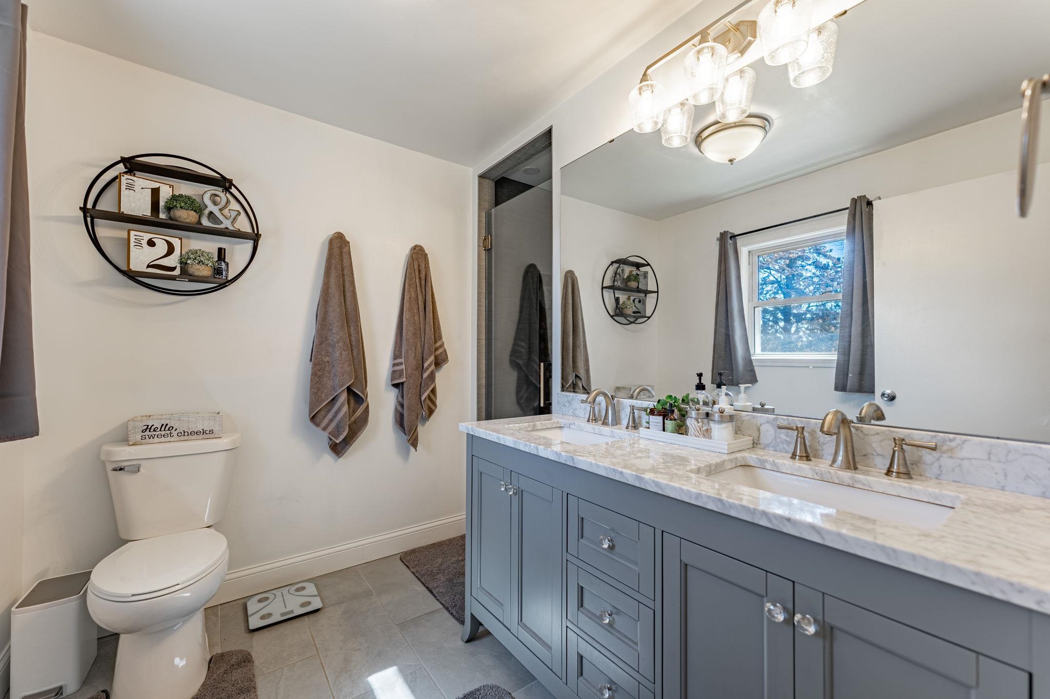 6912 Elevator Road Roscoe, IL 61073 - Photo 13 of 43 a bathroom with a granite countertop toilet sink and a mirror