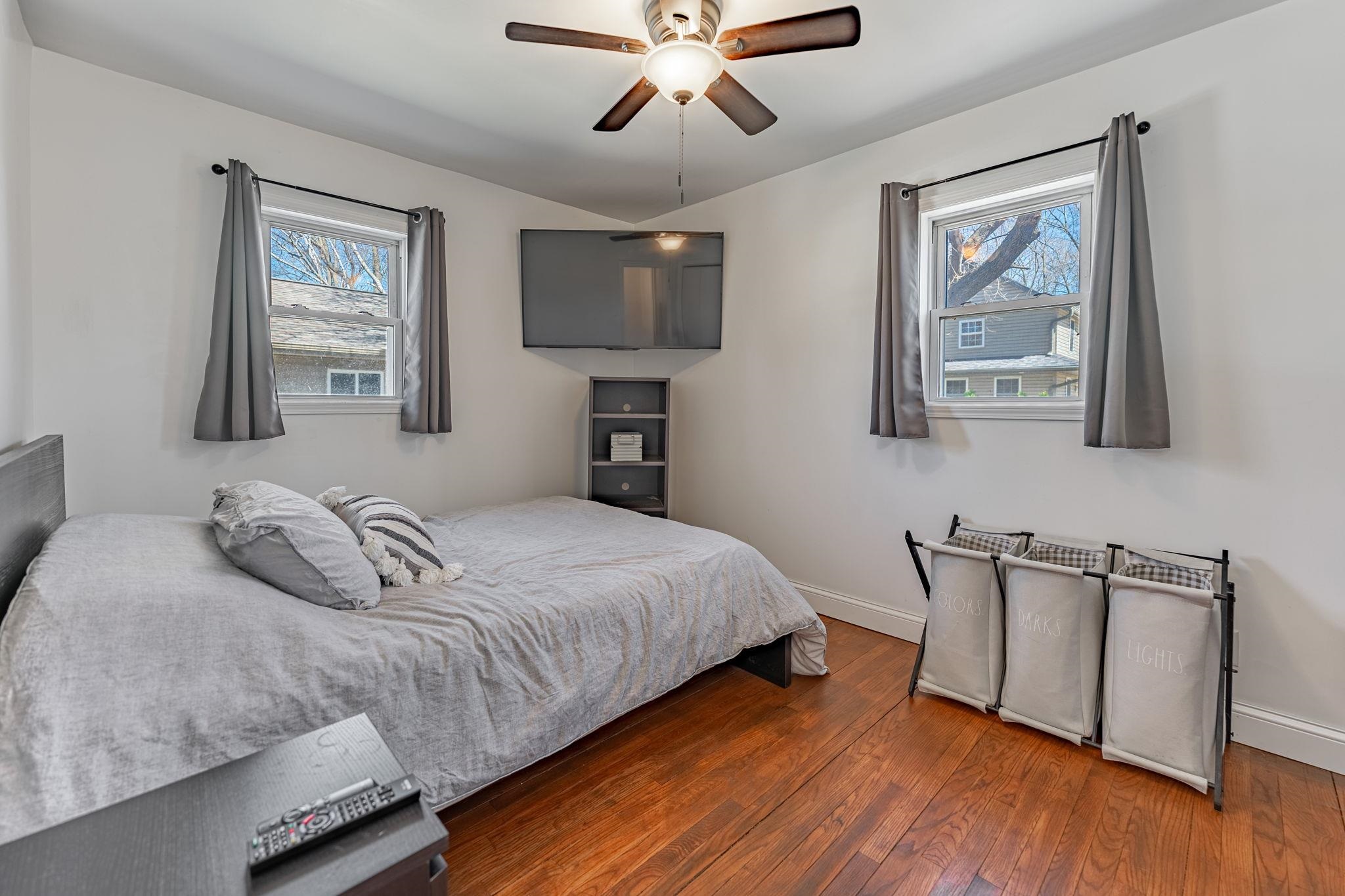 6912 Elevator Road Roscoe, IL 61073 - Photo 17 of 43 a bedroom with a large bed and a chandelier