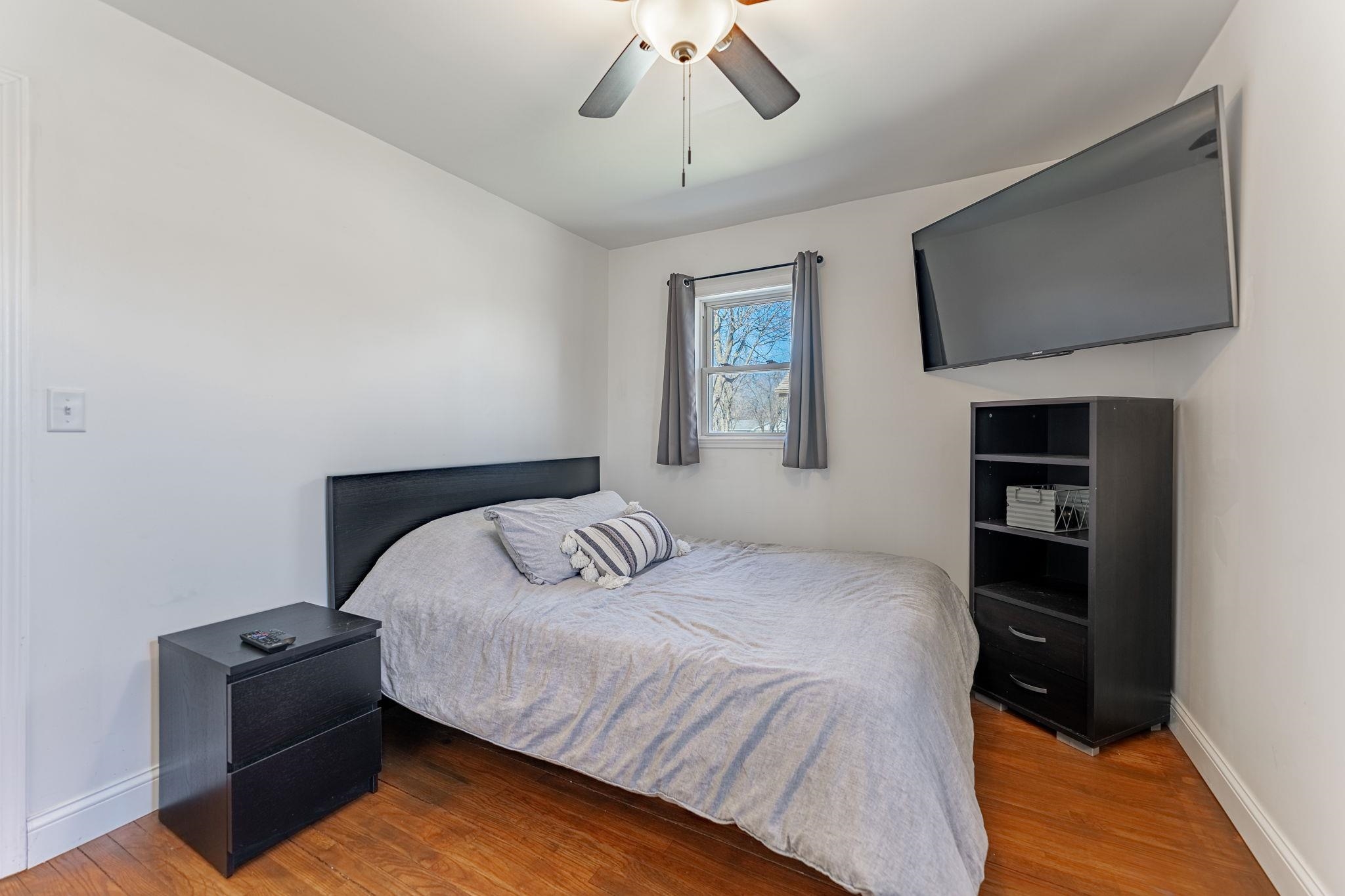 6912 Elevator Road Roscoe, IL 61073 - Photo 18 of 43 a bedroom with a bed and a flat screen tv