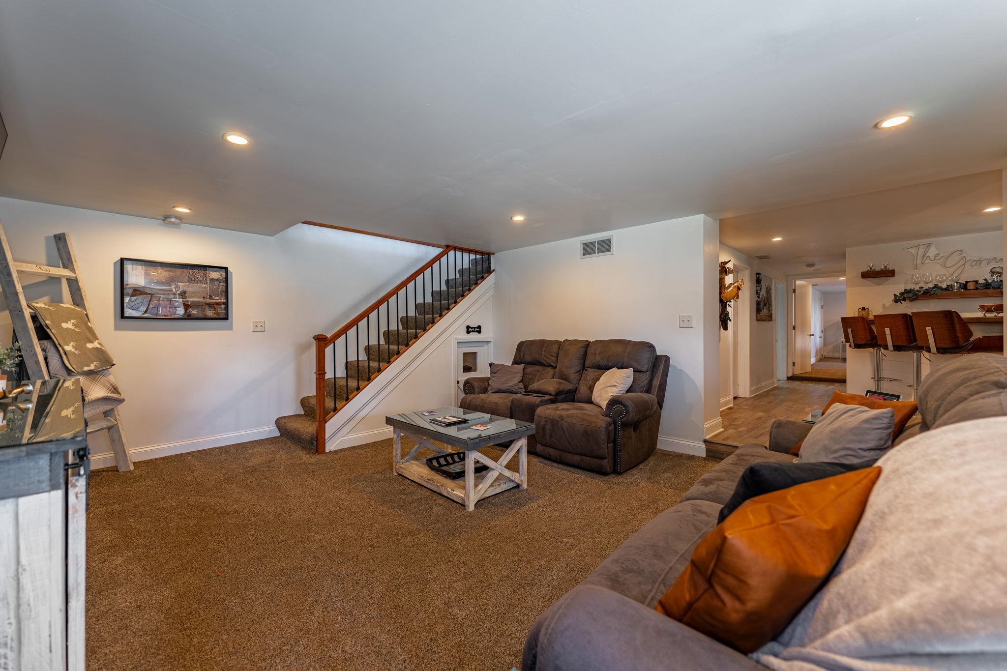 6912 Elevator Road Roscoe, IL 61073 - Photo 21 of 43 a living room with furniture and a flat screen tv