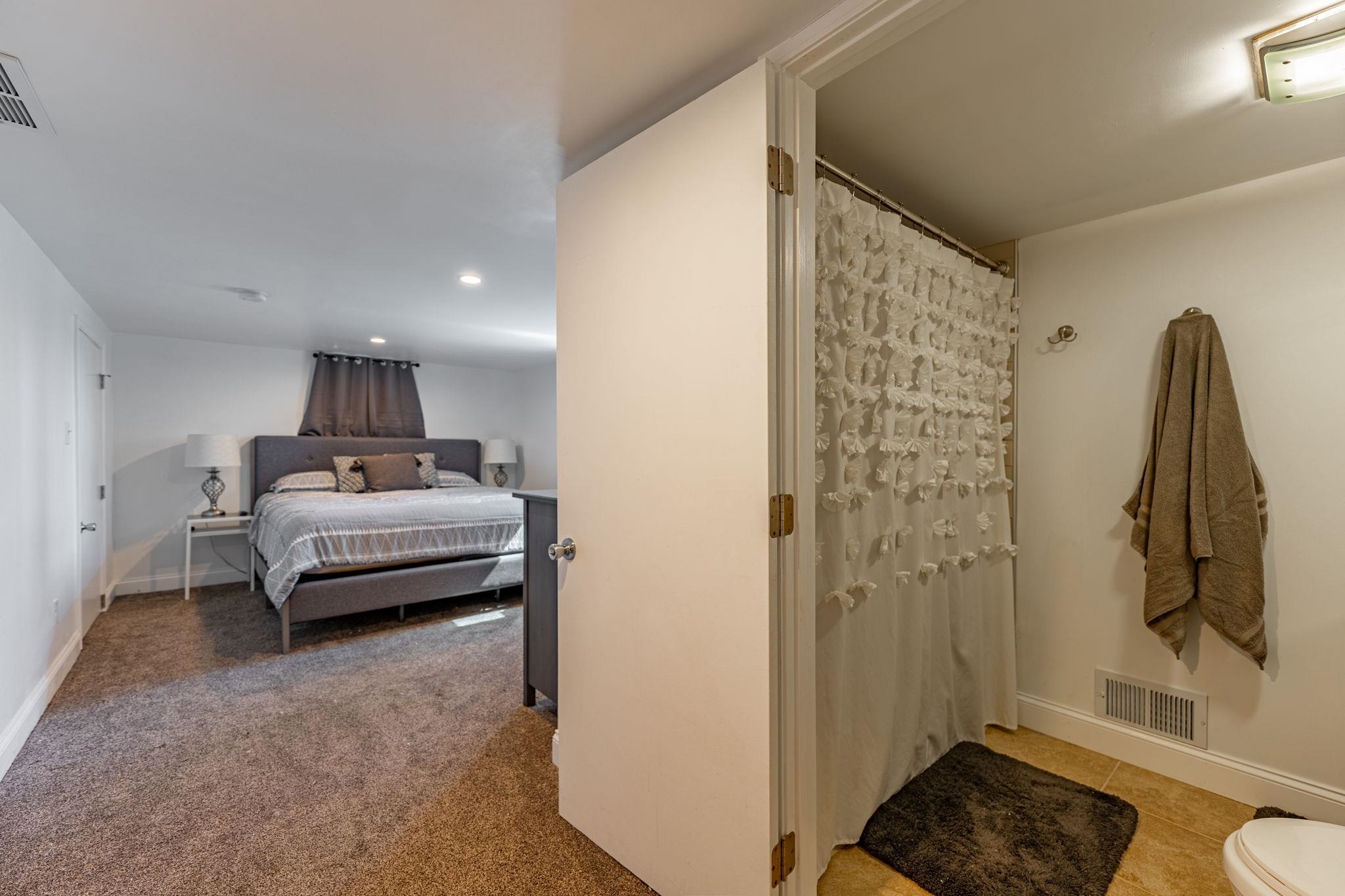 6912 Elevator Road Roscoe, IL 61073 - Photo 24 of 43 a bedroom with a bed and a bathroom