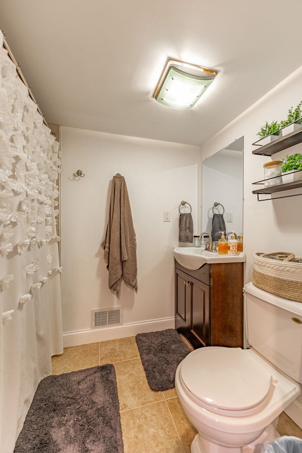 6912 Elevator Road Roscoe, IL 61073 - Photo 25 of 43 a bathroom with a toilet a sink and mirror
