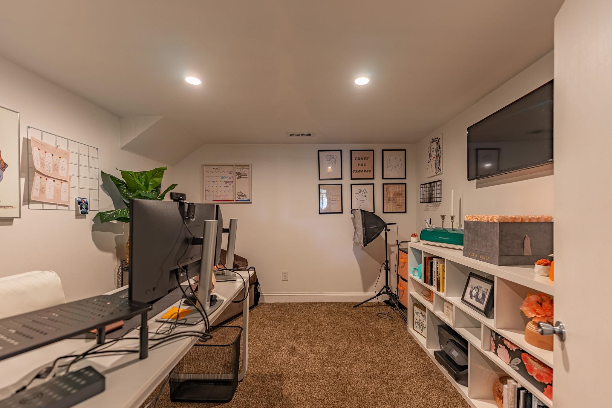 6912 Elevator Road Roscoe, IL 61073 - Photo 27 of 43 a living room with furniture a flat screen tv and a bookshelf