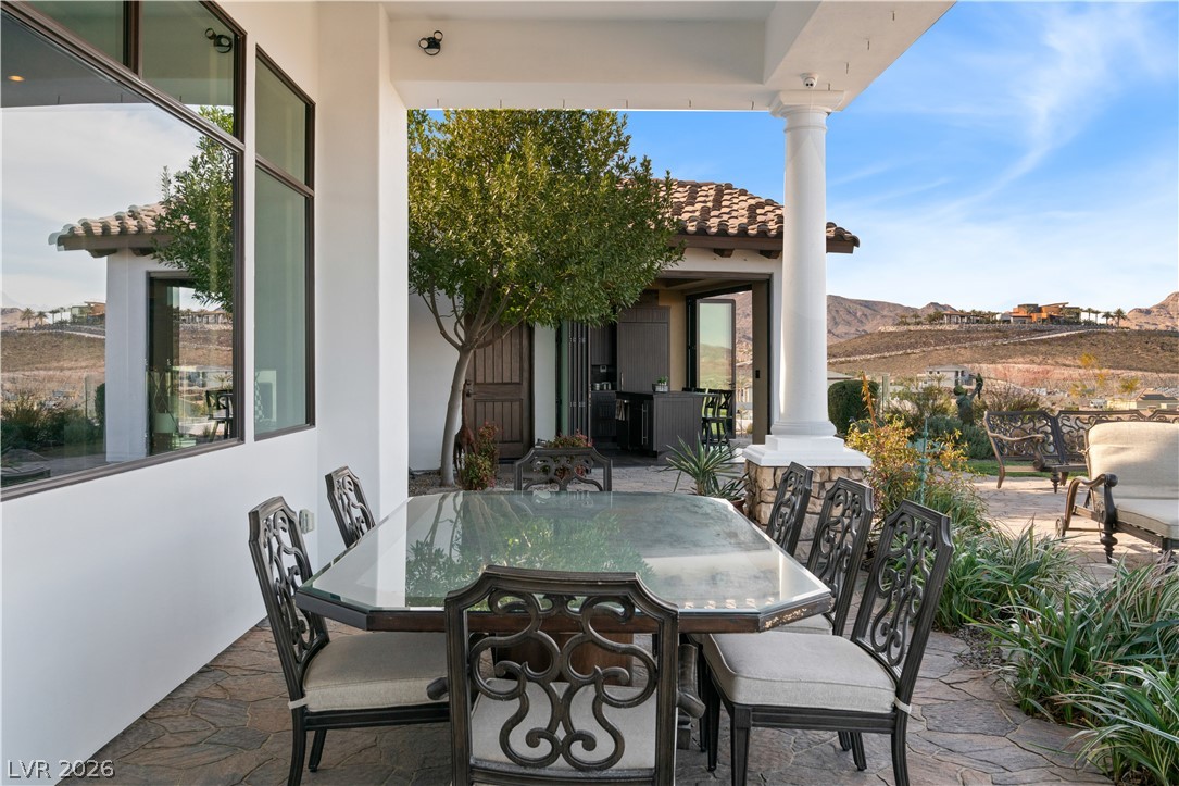 1123 Christian Road Henderson, NV 89002 - Photo 48 of 94 An inviting outdoor dining area features a covered patio with a built-in outdoor kitchen, ideal for entertaining.