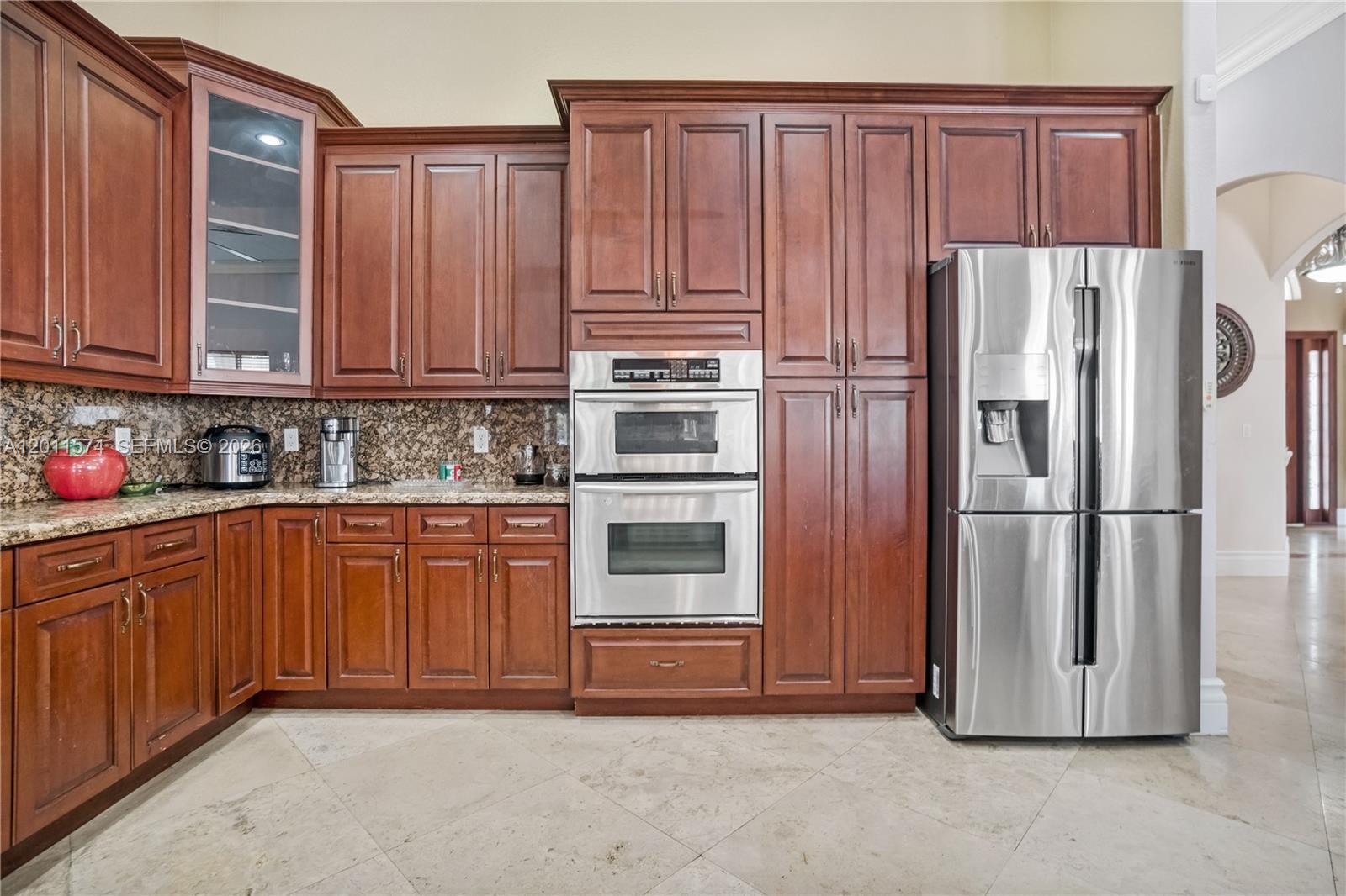 4025 Southwest 128th Avenue Miami, FL 33175 - Photo 11 of 93 a kitchen with stainless steel appliances granite countertop a refrigerator stove and cabinets