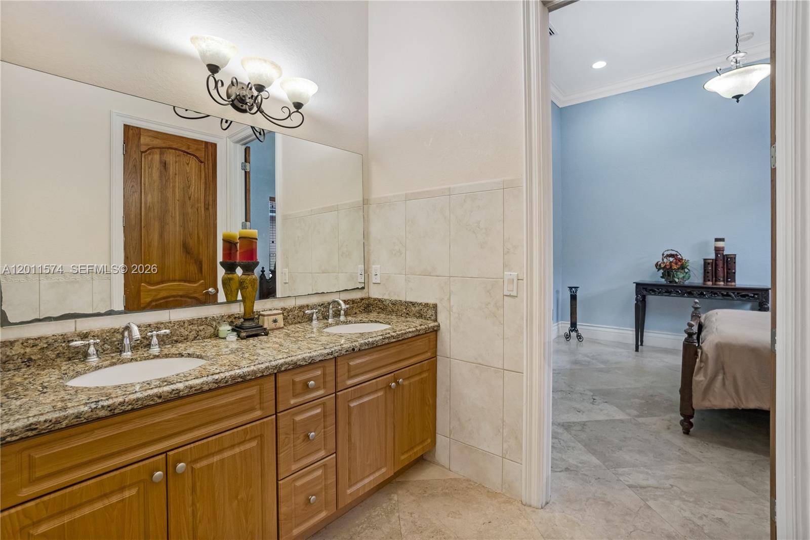 4025 Southwest 128th Avenue Miami, FL 33175 - Photo 28 of 93 a en suite bathroom with a granite countertop sink a mirror and a shower