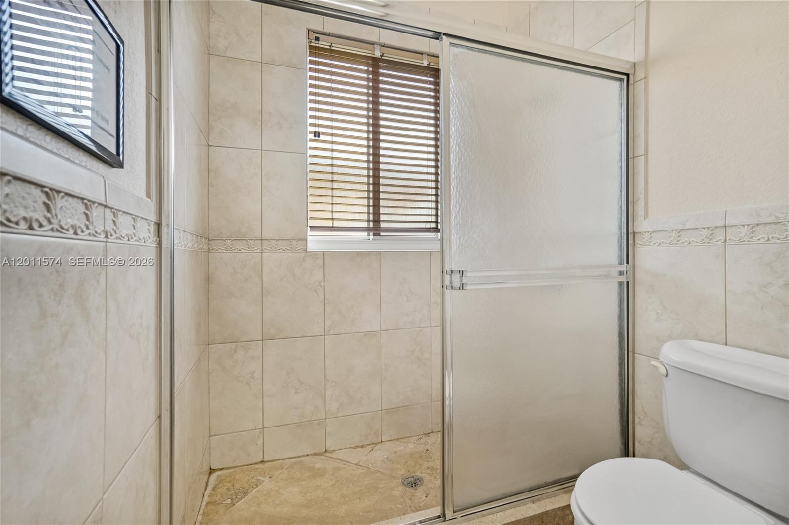 4025 Southwest 128th Avenue Miami, FL 33175 - Photo 29 of 93 a bathroom with a toilet and a shower
