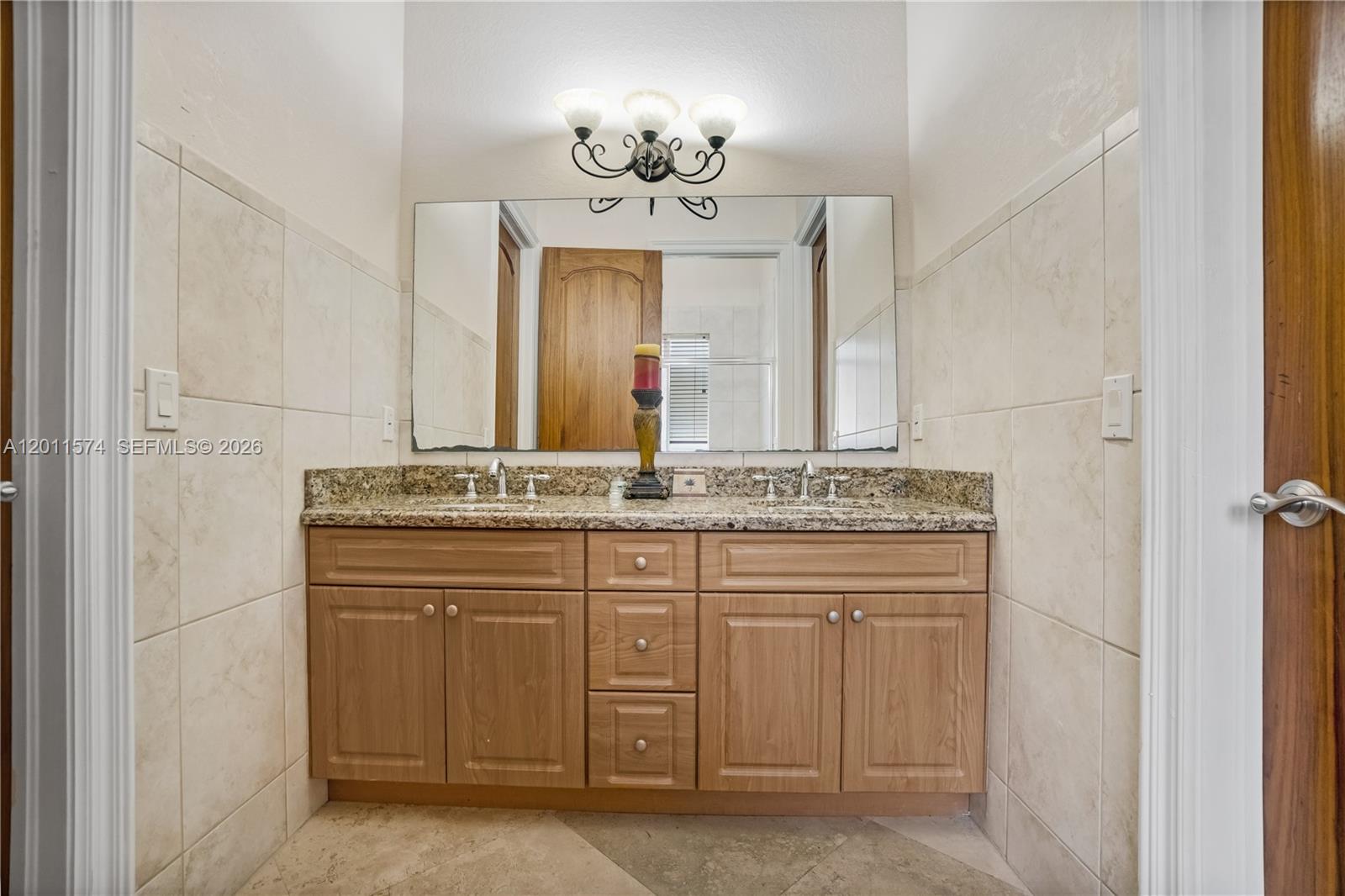 4025 Southwest 128th Avenue Miami, FL 33175 - Photo 30 of 93 a bathroom with a granite countertop sink a mirror and a vanity