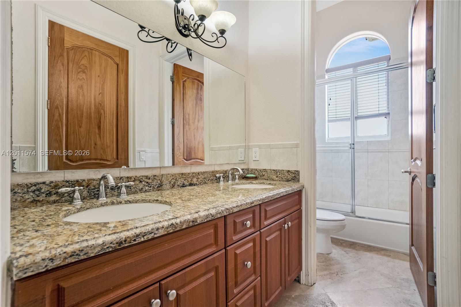 4025 Southwest 128th Avenue Miami, FL 33175 - Photo 36 of 93 a bathroom with a granite countertop sink and a mirror