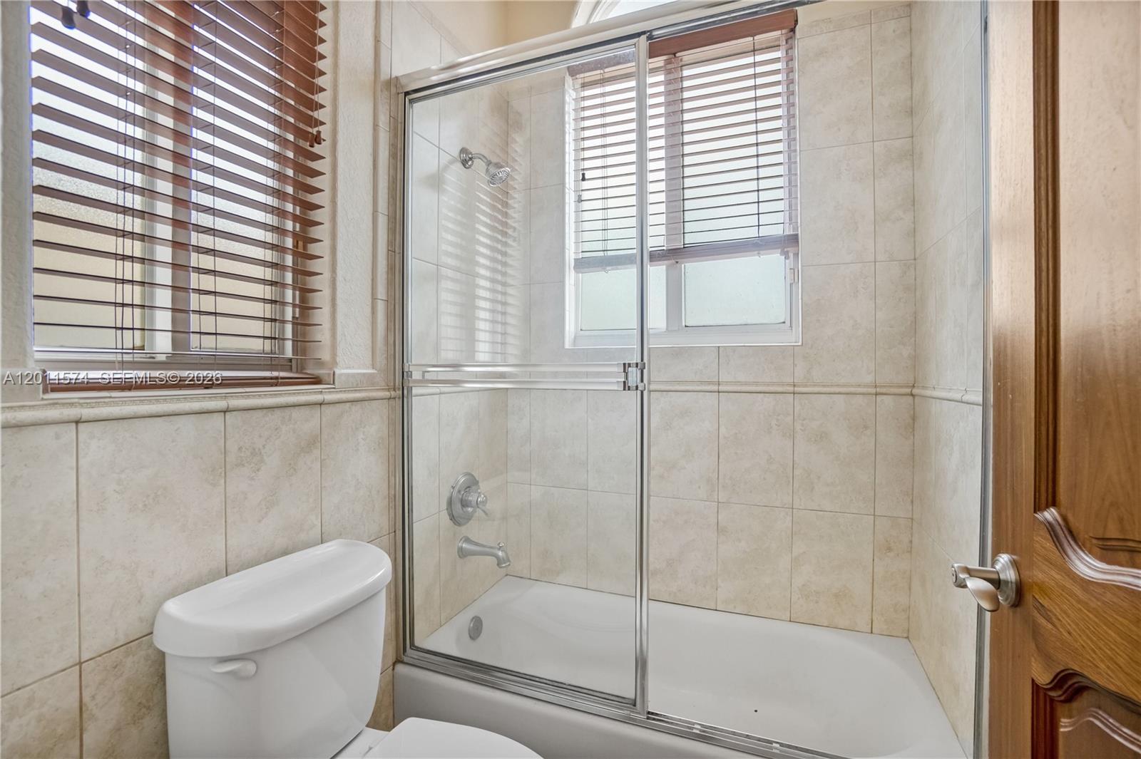 4025 Southwest 128th Avenue Miami, FL 33175 - Photo 38 of 93 a bathroom with a toilet and shower