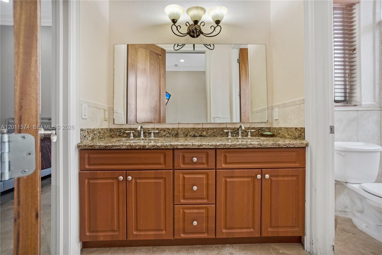 4025 Southwest 128th Avenue Miami, FL 33175 - Photo 39 of 93 a bathroom with a granite countertop sink and a mirror