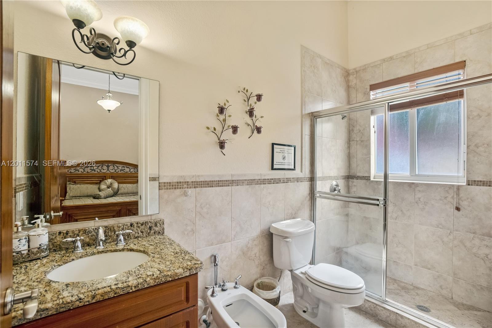 4025 Southwest 128th Avenue Miami, FL 33175 - Photo 42 of 93 a bathroom with a granite countertop sink a toilet and a mirror