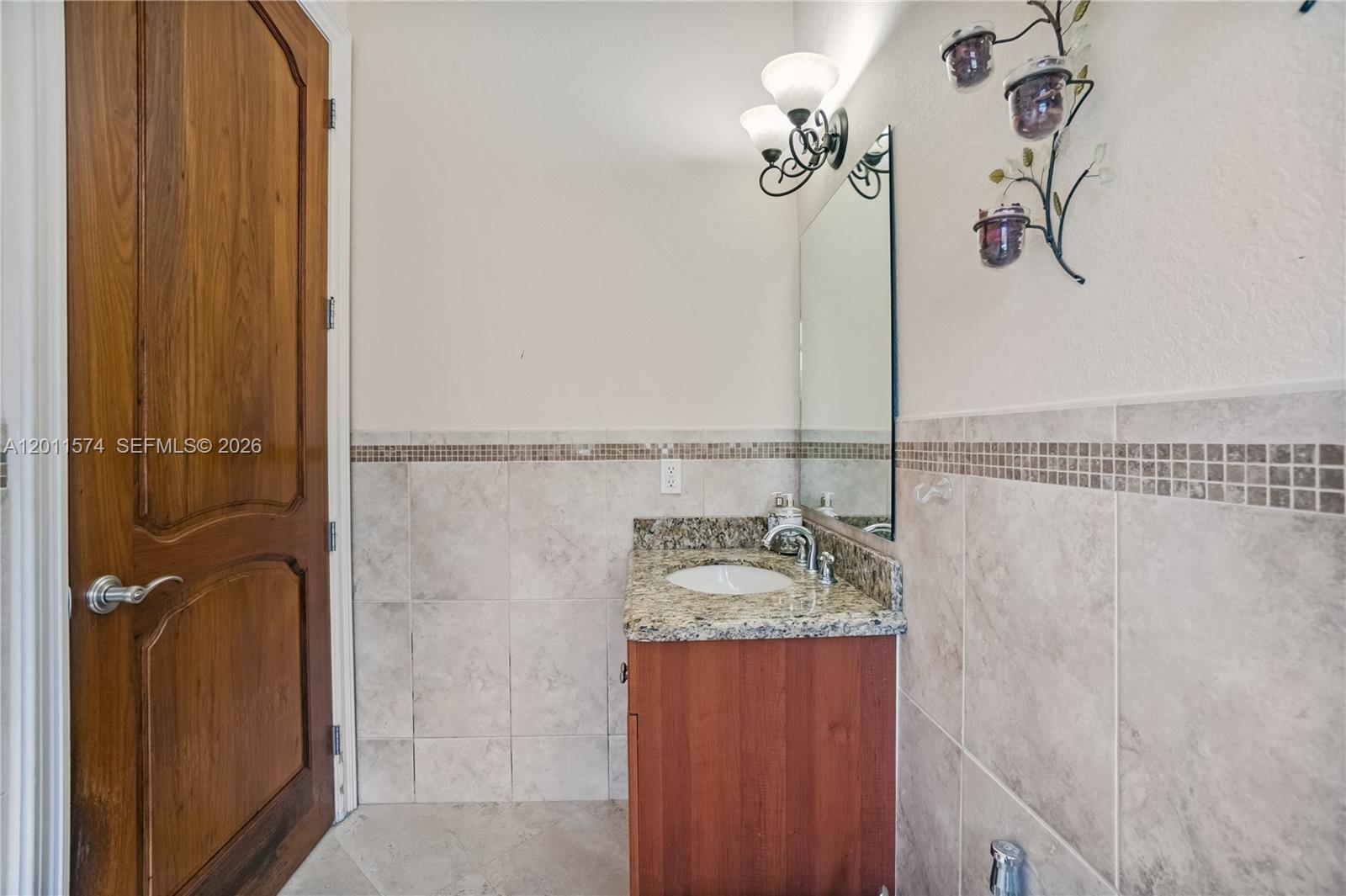 4025 Southwest 128th Avenue Miami, FL 33175 - Photo 43 of 93 a bathroom with a granite countertop shower a mirror and a sink
