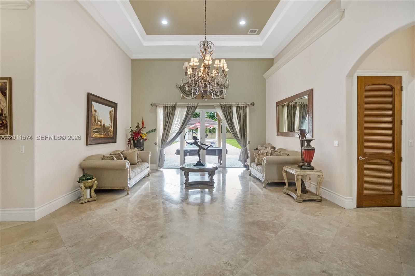 4025 Southwest 128th Avenue Miami, FL 33175 - Photo 55 of 93 a living room with furniture and a chandelier